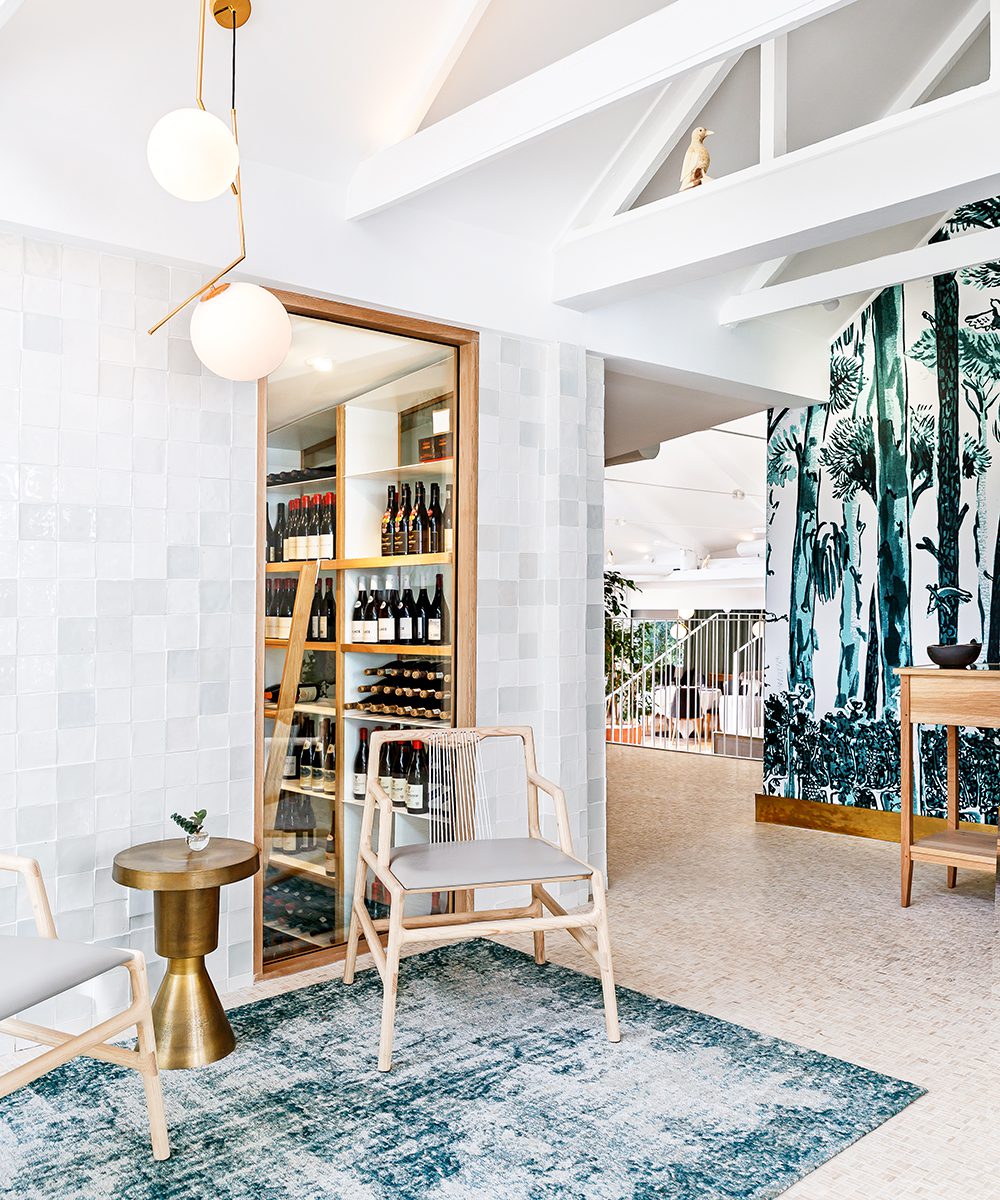 The entrance to La Colombe, with the wine cellar and a sneak peek of the bespoke handpainted wallpaper by artist Lucie de Moyencourt